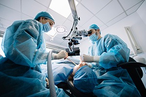 Dentists performing a dental implant surgery