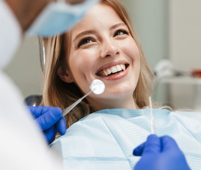 Woman looking up at emergency dentist in Matthews and smiling