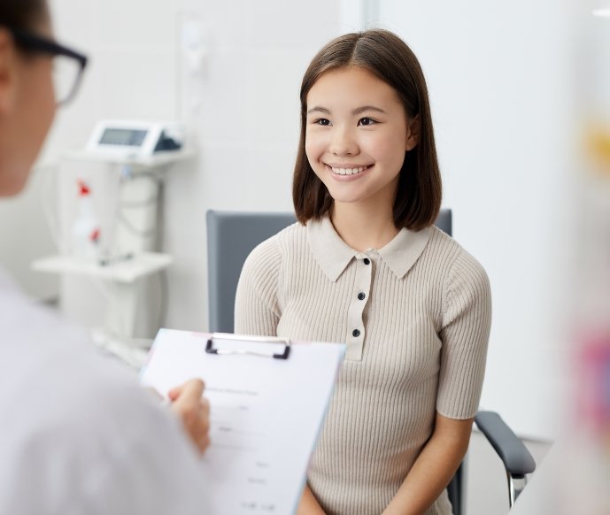 Young woman smiling at her dentist