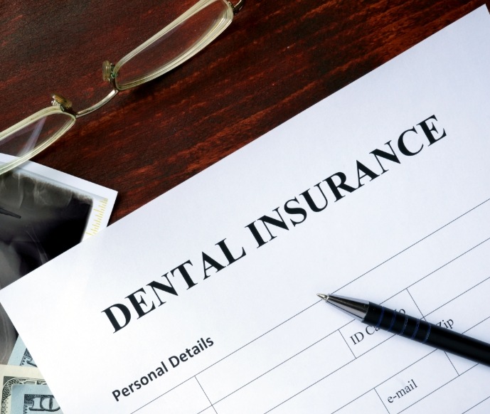 Dental insurance form on a wooden desk