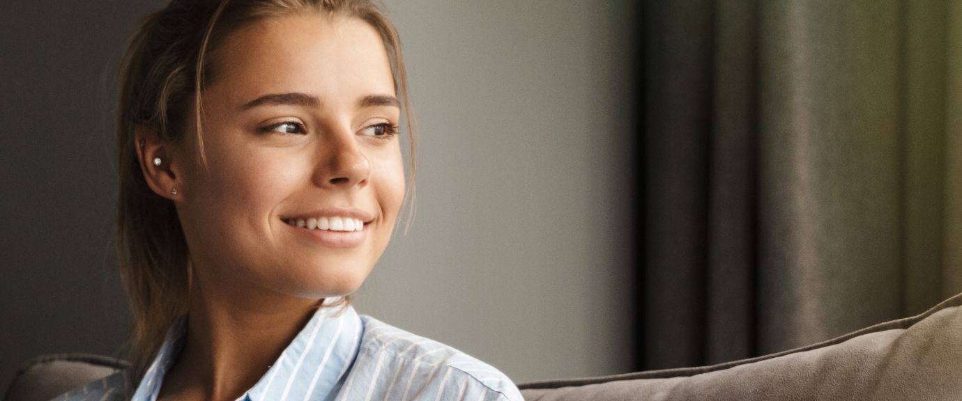 Woman sitting on couch and smiling