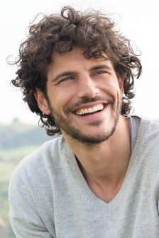 Man in a grey shirt smiling