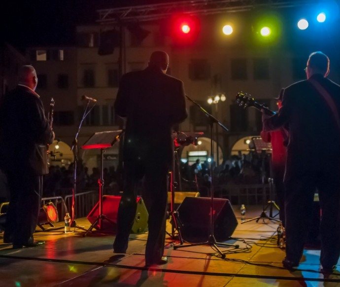 Back shot of a band performing under stage lights