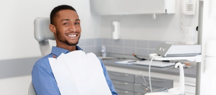 Male dental patient smiling while waiting for preventive dentistry in Matthews