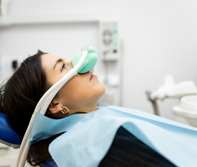 Female dental patient wearing nasal mask for nitrous oxide sedation